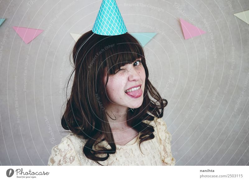 Young woman winking in a birthday party Style Face Wellness Well-being Contentment Feasts & Celebrations Birthday Human being Feminine Youth (Young adults) 1
