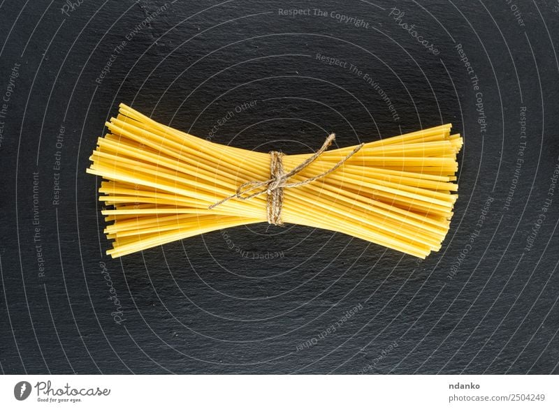 raw spaghetti Dough Baked goods Lunch Dinner Line Eating Fresh Large Long Above Yellow Black Colour Tradition Spaghetti pasta food background Raw Italian