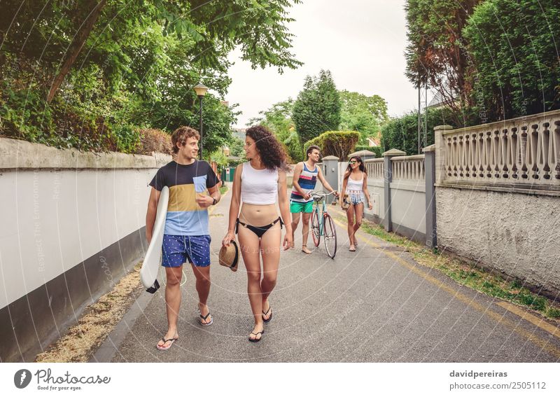 Happy young people walking along road in summer day Lifestyle Joy Leisure and hobbies Vacation & Travel Summer Sports Woman Adults Man Friendship Couple
