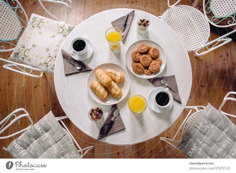 Top view of healthy breakfast served over a table Yoghurt Fruit Croissant Breakfast Juice Coffee Plate Bowl Spoon Table Restaurant Fresh Hot Delicious Above