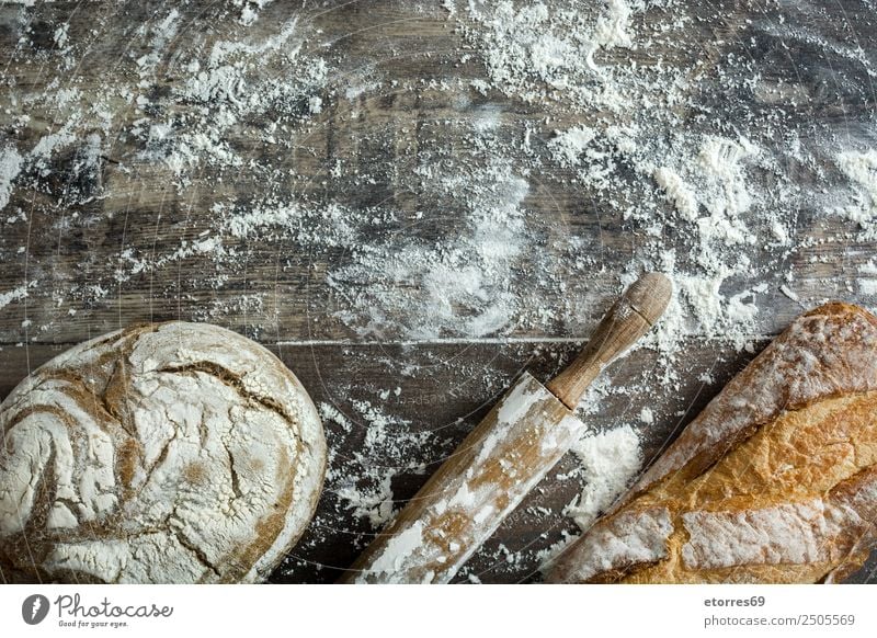 Bread and flour on a rustic wooden background Make Kitchen Apron Flour Yeast Home-made Baking Dough Preparation Stir Ingredients Wood Neutral Background Rustic
