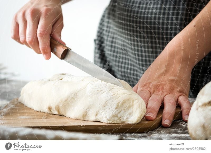 Woman cutting bread dough on wooden table Bread Dough Make kneading Hand Kitchen Apron Flour Yeast Home-made Baking Human being Preparation Stir Ingredients