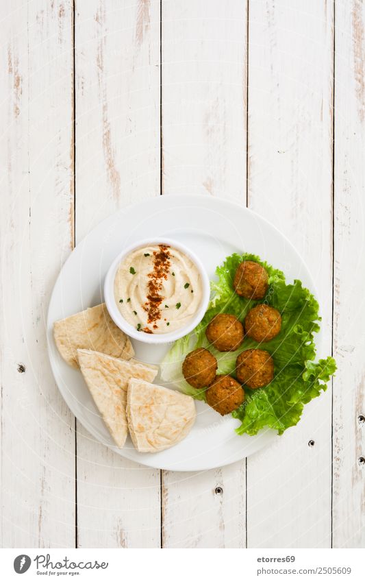 Falafel and vegetables in bowl on white wood Food Healthy Eating Food photograph Vegetable Grain Asian Food Bowl Fresh Brown falafel Chickpeas Tomato Lettuce
