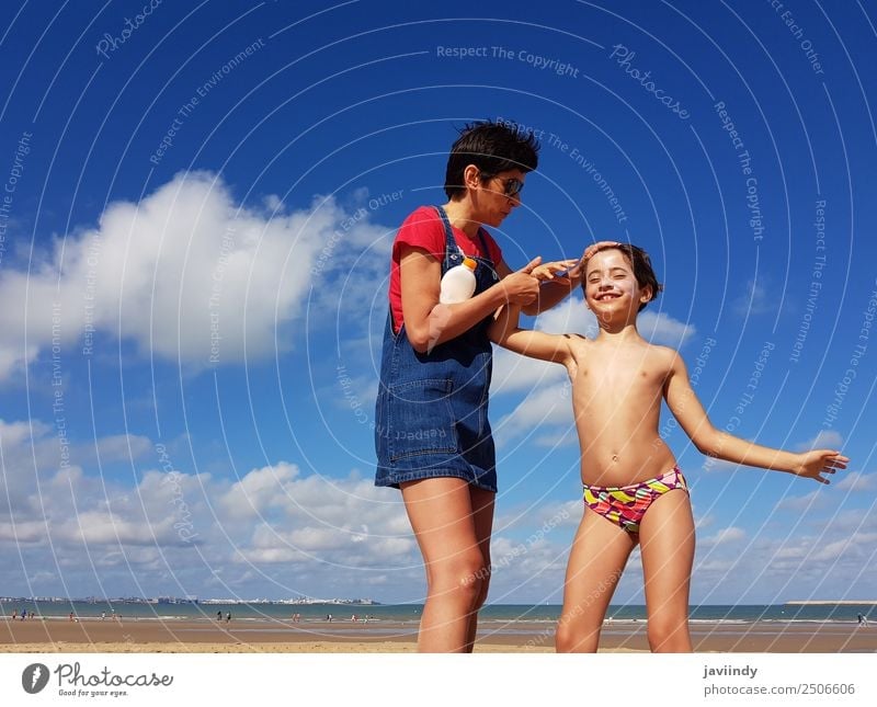 Mother and little daughter having fun on the beach in winter Lifestyle Cream Vacation & Travel Summer Beach Child Human being Girl Young woman