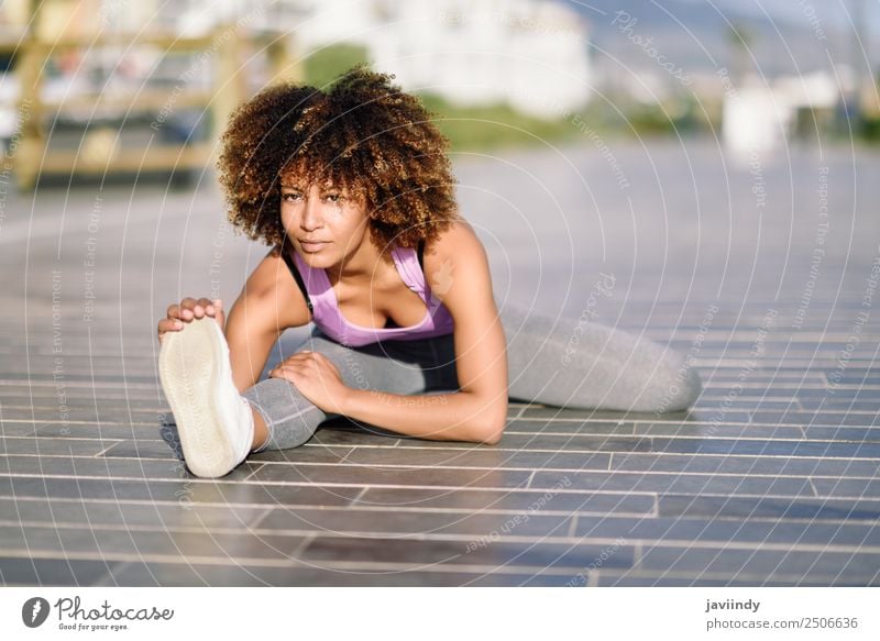 Young black woman doing stretching after running outdoors Lifestyle Beautiful Hair and hairstyles Wellness Leisure and hobbies Sports Jogging Feminine