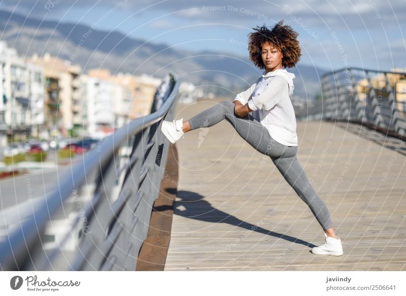 Young black woman doing stretching after running outdoors - a Royalty Free  Stock Photo from Photocase