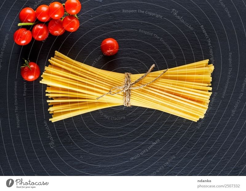 raw Italian long pasta Vegetable Dough Baked goods Vegetarian diet Italian Food Eating Fresh Large Long Above Yellow Red Black Colour Tradition Spaghetti food