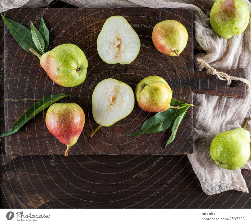 Fresh organic pears background. Ripe yellow large pears in wooden