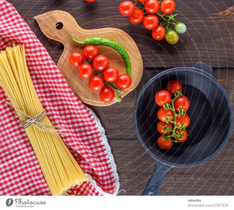 ingredients for cooking food Vegetable Dough Baked goods Italian Food Pan Wood Fresh Large Long Above Brown Yellow Red Black Tradition Spaghetti pasta Tomato
