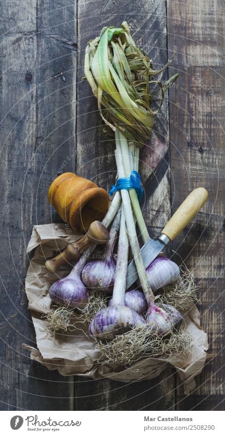 Bunch of garlic with kitchenware on wooden background Vegetable Herbs and spices Nutrition Eating Knives Kitchen Nature Plant Agricultural crop Feeding Fresh