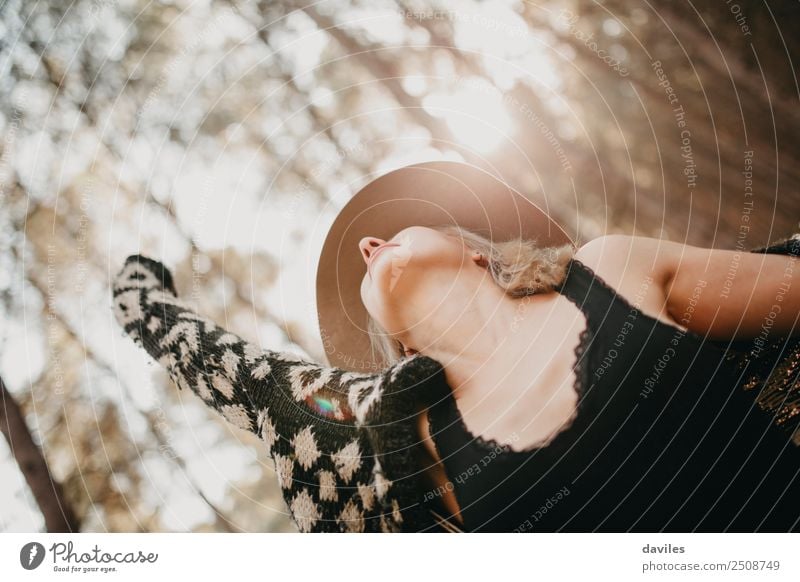 Blonde woman with a hat expressing herself and breathing in the middle of the forest. Lifestyle Joy Beautiful Health care Wellness Well-being Vacation & Travel