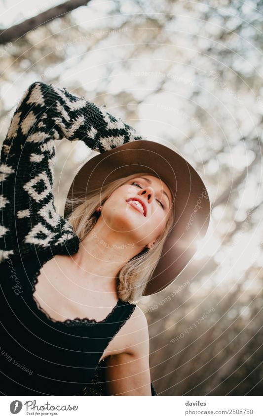 Portrait of blonde girl with a hat breathing deeply with closed eyes in the middle of nature. Lifestyle Happy Beautiful Health care Wellness Vacation & Travel
