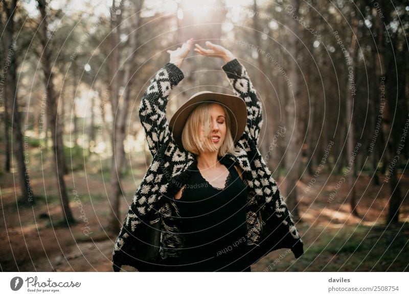 Cool blonde girl with hat and black clothes dancing in the middle of the forest Lifestyle Joy Wellness Leisure and hobbies Vacation & Travel Freedom Human being