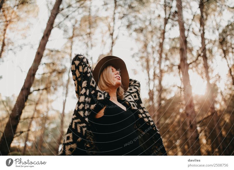 Blonde girl with hat and hands in the head enjoying relaxed the nature in forest. Lifestyle Wellness Relaxation Vacation & Travel Freedom Human being Feminine