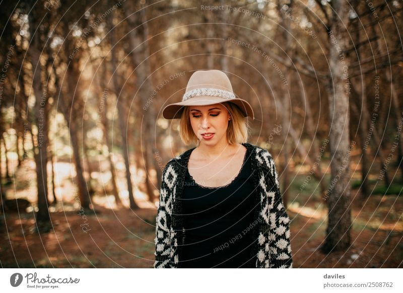 Portrait of young woman with a hat taking a walk in the forest at sunset Lifestyle Leisure and hobbies Vacation & Travel Adventure Freedom Sightseeing
