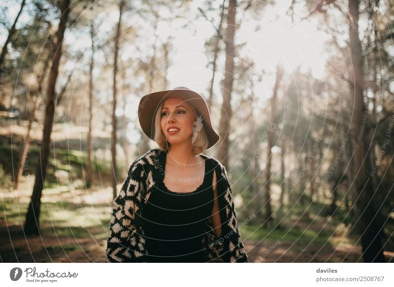 Young woman taking a walk in the forest - a Royalty Free Stock