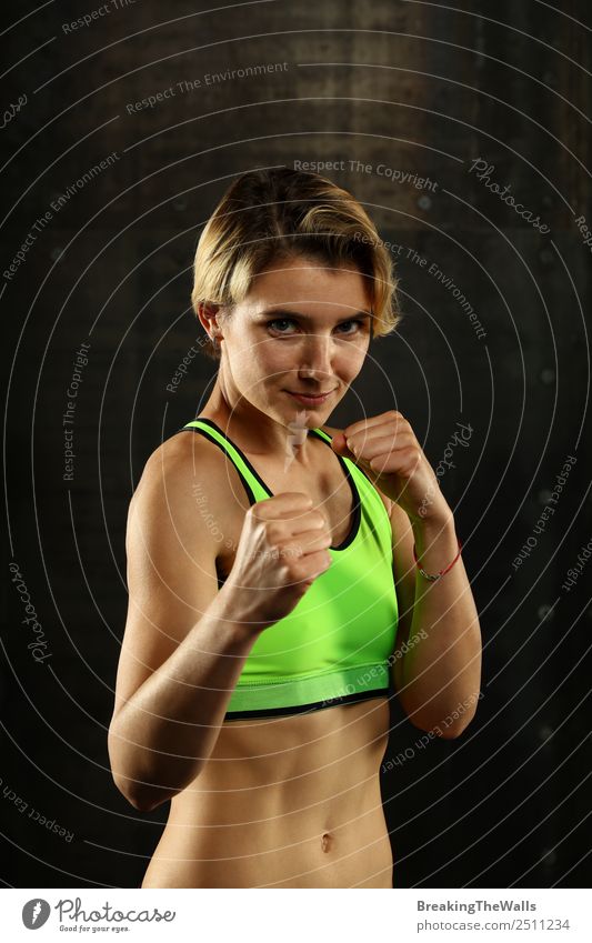 Woman standing in boxing stance ready to fight - a Royalty Free Stock