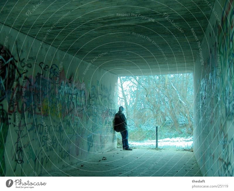 questionable Pedestrian underpass Loneliness Winter Masculine Tunnel Withdraw Mural painting Graffiti Man Underpass Snow Human being
