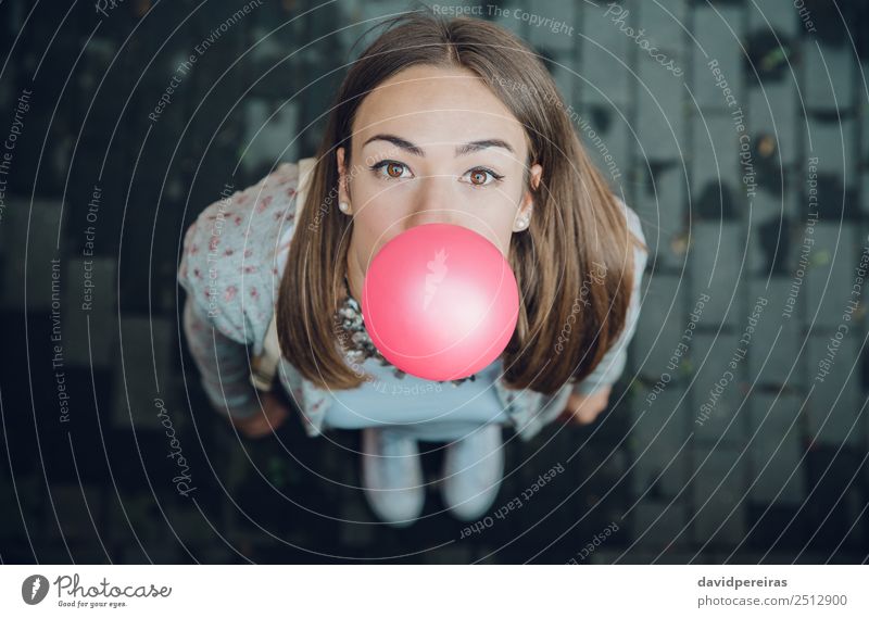 Top view of young teenage girl blowing bubble gum Lifestyle Joy Happy Beautiful Face Human being Woman Adults Youth (Young adults) Mouth Lips Fashion Brunette