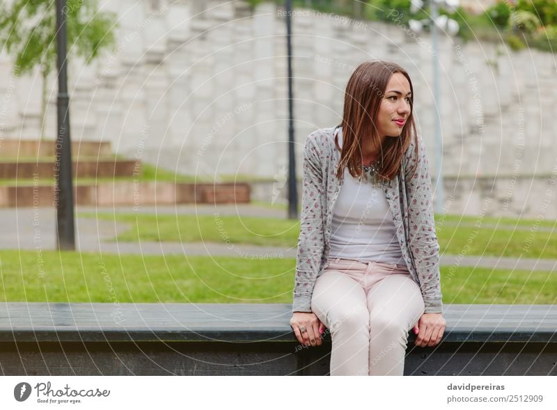 Long Legs Fashion Blonde Girl Sitting on Bench. Street Fashion. Stock Photo