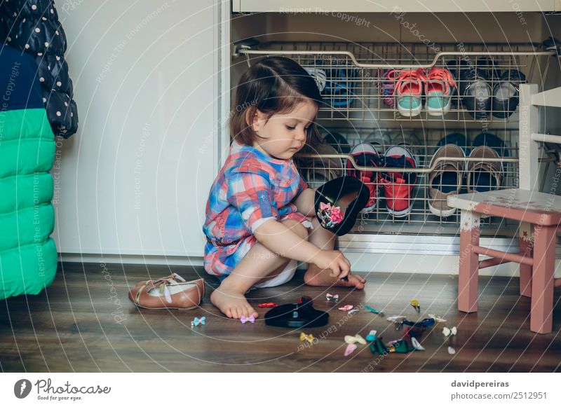 Baby girl playing with hair clips sitting in the floor Lifestyle Joy Happy Beautiful Playing House (Residential Structure) Child Human being Woman Adults