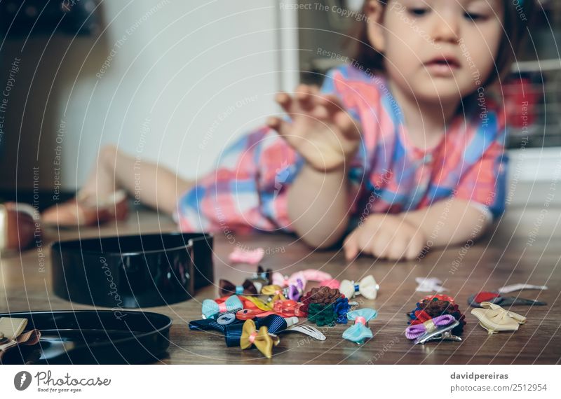 Baby girl playing with hair clips lying in the floor Lifestyle Joy Happy Beautiful Playing House (Residential Structure) Child Human being Woman Adults Infancy