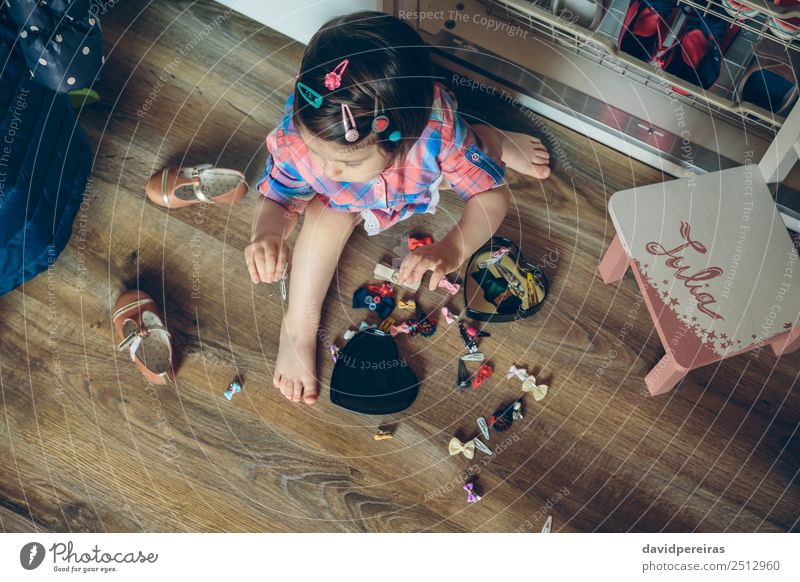 Baby girl playing with hair clips sitting in the floor Lifestyle Joy Happy Beautiful Playing House (Residential Structure) Child Human being Woman Adults