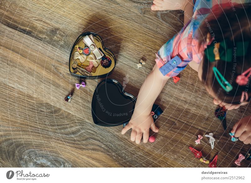Baby girl playing with hair clips sitting in the floor Lifestyle Joy Happy Beautiful Playing Child Human being Woman Adults Infancy Hand Aircraft Accessory