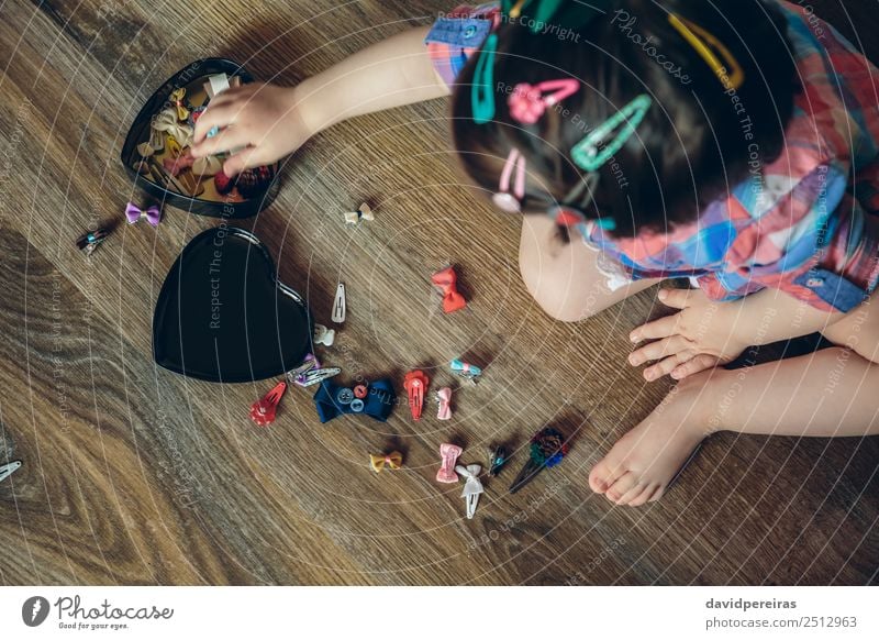 Baby girl playing with hair clips sitting in the floor Lifestyle Joy Happy Beautiful Hair and hairstyles Playing House (Residential Structure) Child Human being