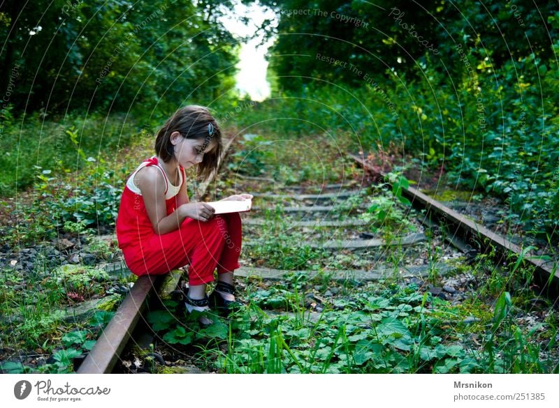 The way Human being Child Girl Infancy 1 3 - 8 years 8 - 13 years Book Reading Nature Landscape Earth Summer Beautiful weather Tree Grass Bushes Park Forest