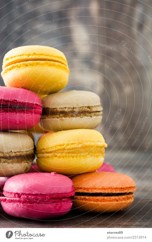 Colored macaroons on rustic wooden background Macaron Sweet Candy Food Food photograph Dessert French Delicious Snack Cookie Tradition Pink Wood Tasty Purple