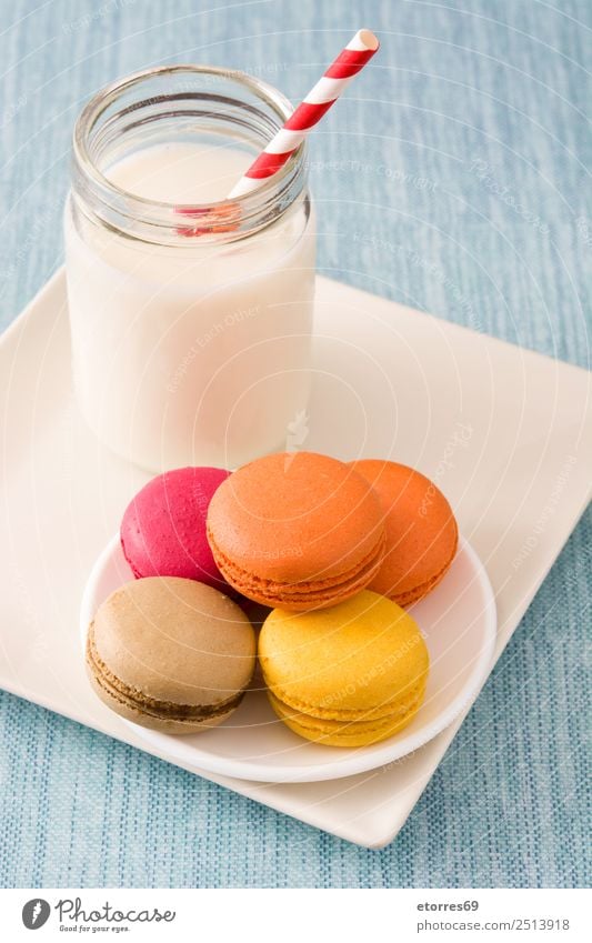 Milk and colored macaroons on blue background Macaron Sweet Candy Food Healthy Eating Food photograph Dessert French Delicious Snack Cookie Tradition Pink Wood