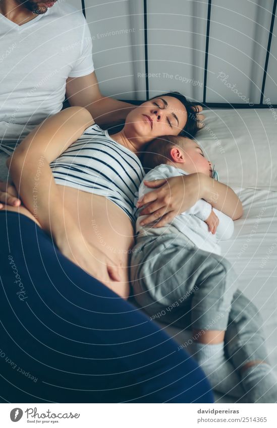 Man looking his wife and son Happy Beautiful Relaxation Bedroom Child Human being Baby Toddler Woman Adults Parents Mother Father Family & Relations Couple Love