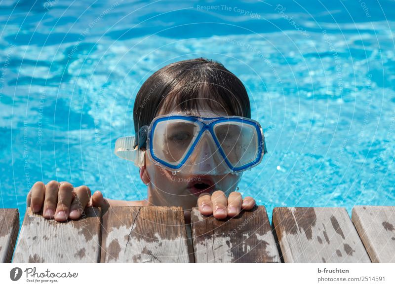 Child with diving goggles in pool Life Swimming pool Swimming & Bathing Vacation & Travel Summer vacation Dive Infancy Face Fingers 1 Human being Looking Blue