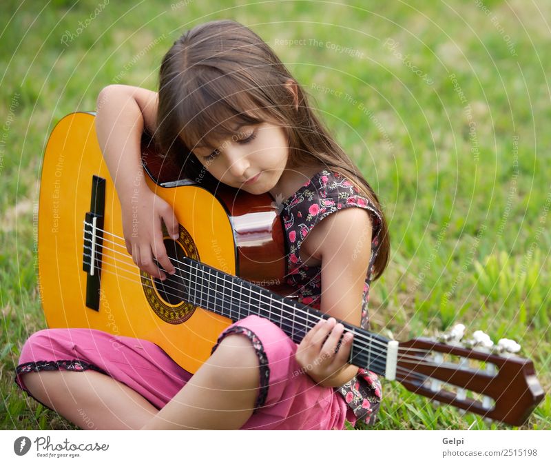 Girl with a guitar Music Child School Human being Boy (child) Guitar Musical notes Flower Grass Green Pink girl student spanish handsome people instrument