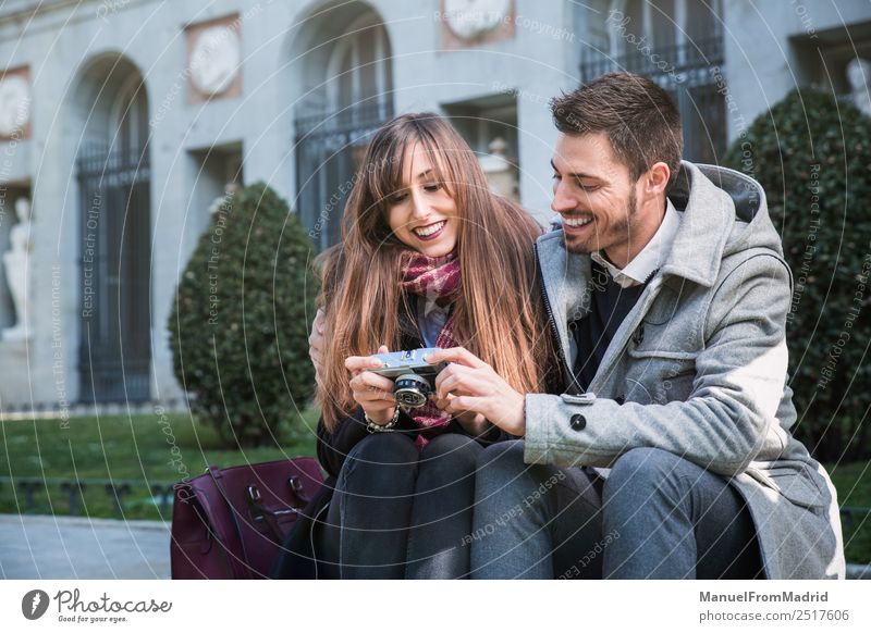 couple taking pictures in the street Lifestyle Joy Beautiful Vacation & Travel Tourism Sightseeing Winter Camera Human being Woman Adults Friendship Couple