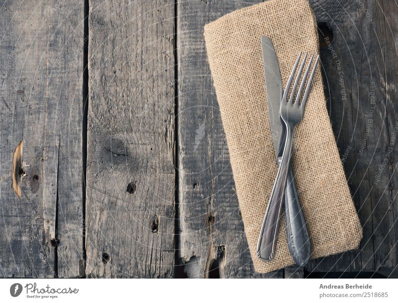 Old cutlery on a wooden table Lunch Banquet Cutlery Knives Fork Style Restaurant Retro antique Background picture black bare brown cloth copy decoration dining