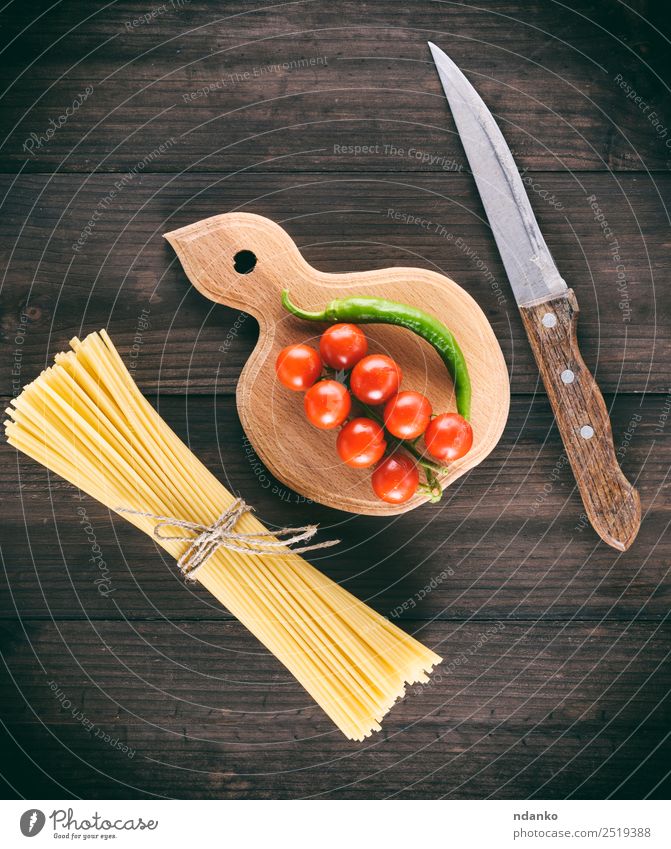 raw Italian long pasta Vegetable Dough Baked goods Fresh Large Long Above Yellow Red Black Colour Tradition Spaghetti food Tomato Cherry Sauce branch Mature