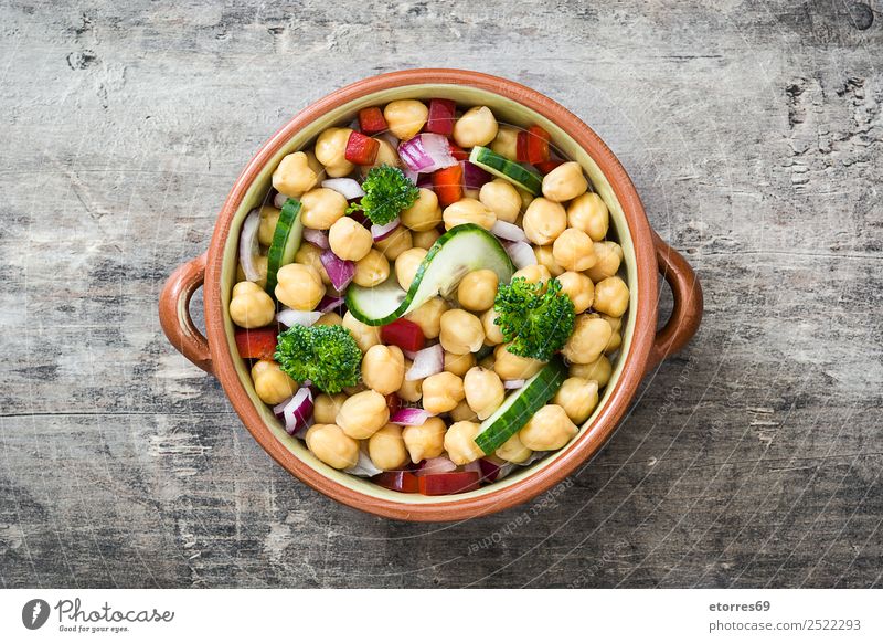 Chickpea salad in bowl on wooden background Chickpeas Salad Cucumber Onion Broccoli Vegetable Vegan diet Vegetarian diet Pepper White Healthy Healthy Eating