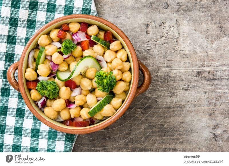 Chickpea salad in bowl on wooden background Chickpeas Salad Cucumber Onion Broccoli Vegetable Vegan diet Vegetarian diet Pepper White Healthy Healthy Eating
