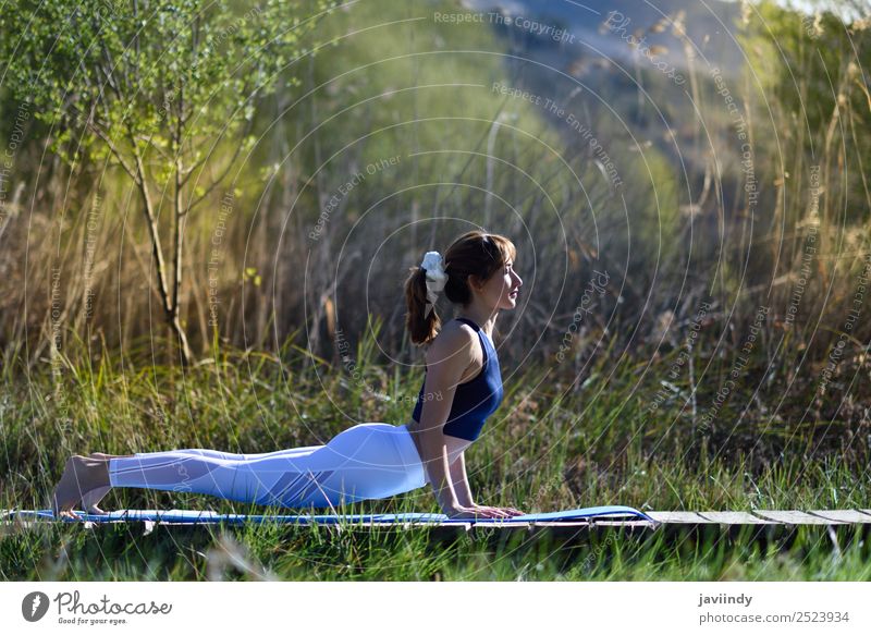 Young woman doing yoga in nature. Lifestyle Beautiful Body Relaxation Meditation Summer Sports Yoga Human being Youth (Young adults) Woman Adults 1
