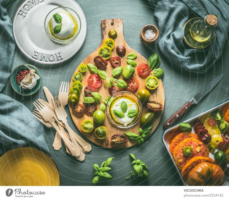 Colourful tomatoes with mozzarella cheese on the kitchen table Food Cheese Vegetable Lettuce Salad Herbs and spices Nutrition Lunch Dinner Buffet Brunch