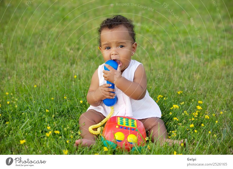 Adorable little black girl with big phone Herbs and spices Beautiful Playing Freedom Garden Child Telephone Baby Toddler Environment Nature Flower Grass Meadow