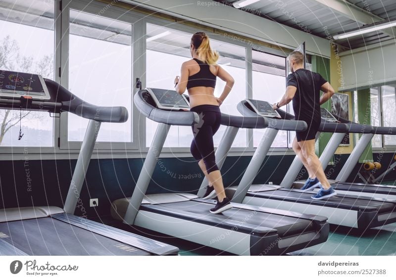 People running over treadmill in a training session Lifestyle Leisure and hobbies Sports Jogging Human being Woman Adults Man Friendship Sneakers Movement