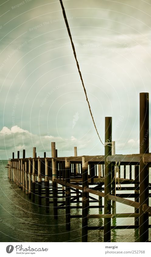 Connection to the top: a wooden footbridge into the sea with a rope to the top Environment Nature Water Sky Clouds Storm clouds Horizon Weather Waves Beach