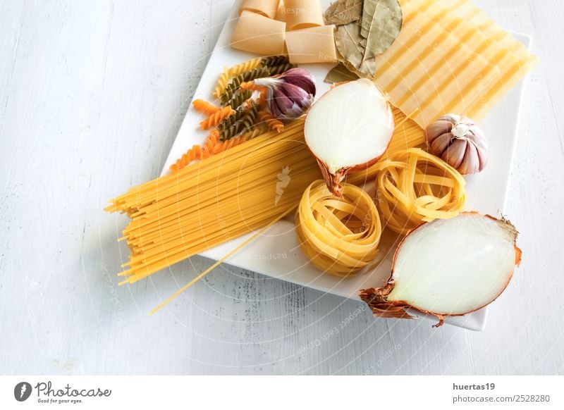 Raw Italian pasta Food Italian Food Crockery Plate Healthy Eating Yellow Green onions Garlic Olive oil Spaghetti fettuccine tagliatelle healthy spirals