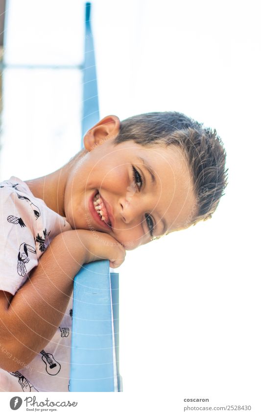 Little boy leaning on a railing in a white and blue village Lifestyle Joy Happy Beautiful Face Vacation & Travel Summer Child School Human being Masculine