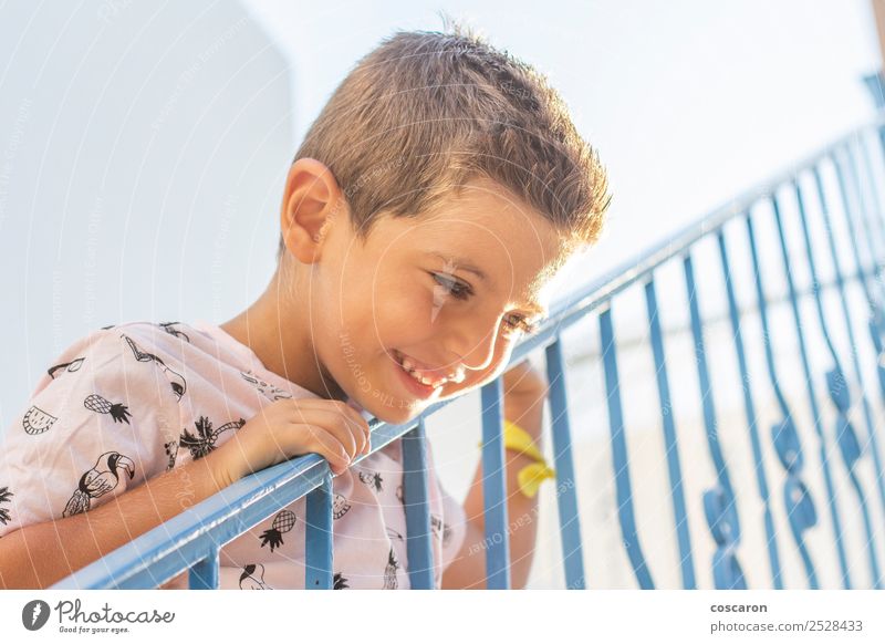 Little boy leaning on a railing in a white and blue village Lifestyle Joy Happy Beautiful Face Vacation & Travel Tourism Summer Summer vacation Child School