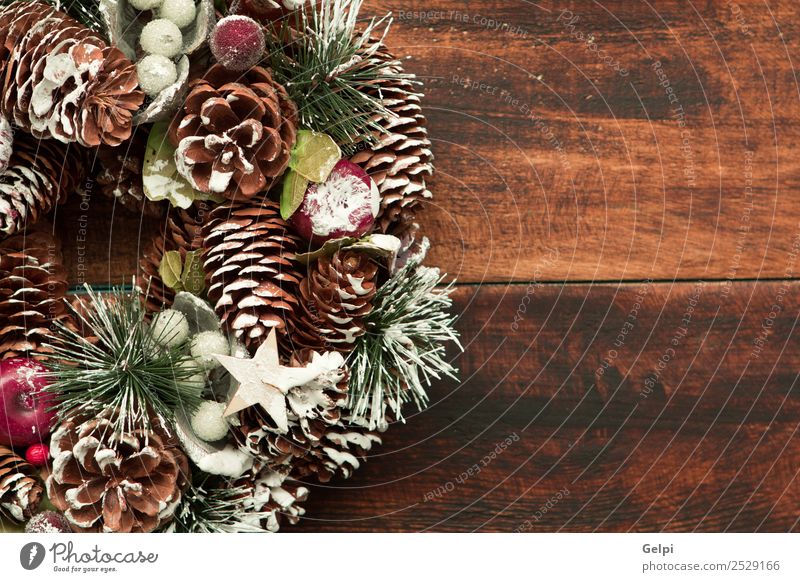 Delicate Christmas wreath of pine cones on wooden background Fruit Apple Beautiful Winter Snow Decoration Feasts & Celebrations Christmas & Advent Ornament
