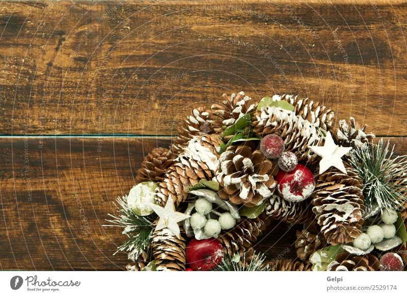 Delicate Christmas wreath of pine cones on wooden background Fruit Apple Beautiful Winter Snow Decoration Feasts & Celebrations Christmas & Advent Ornament